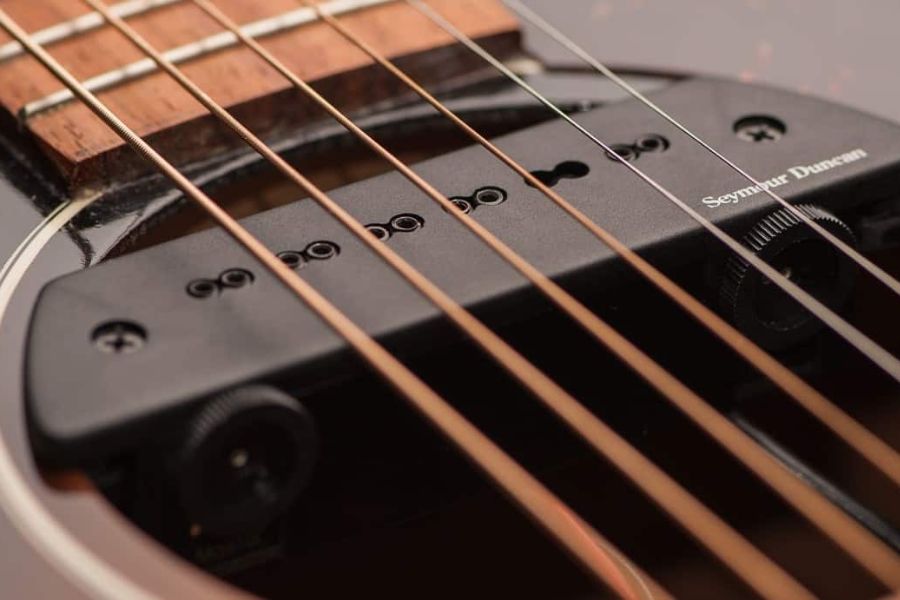 Acoustic electric guitar includes a pickup that captures the vibrations of the strings