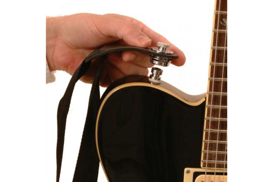 Some guitar players attach strap locks for security